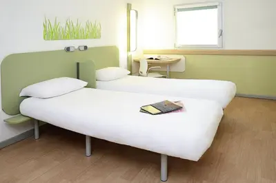Un ou plusieurs lits dans un hébergement de l'établissement ibis Budget Courbevoie Paris La Défense