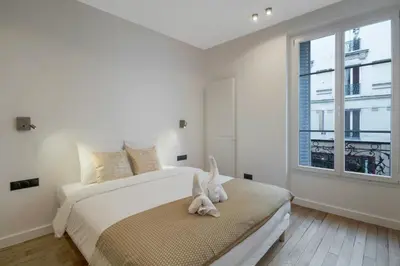 Un ou plusieurs lits dans un hébergement de l'établissement Premium Suites - Arc de Triomphe - Trocadéro