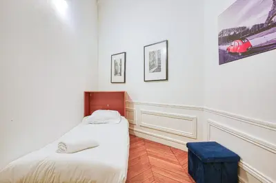 Un ou plusieurs lits dans un hébergement de l'établissement Apartment Arc de Triomphe Champs Elysées