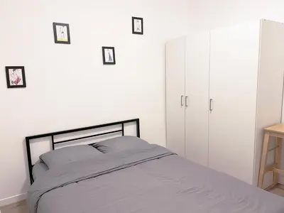 Un ou plusieurs lits dans un hébergement de l'établissement Charmant appartement proche de la Tour Eiffel