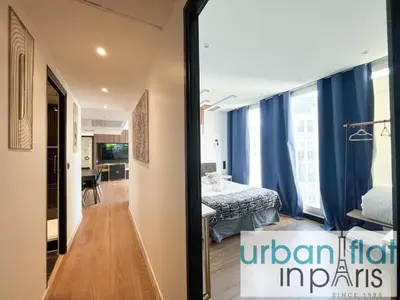 Un ou plusieurs lits dans un hébergement de l'établissement Urban Flat 128 - Art Rock 4BDR Flat near Champs-Elysees