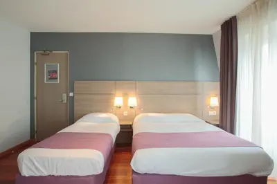 Un ou plusieurs lits dans un hébergement de l'établissement Grand Hotel du Loiret
