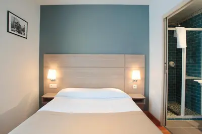 Un ou plusieurs lits dans un hébergement de l'établissement Grand Hotel du Loiret