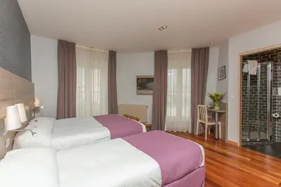 Un ou plusieurs lits dans un hébergement de l'établissement Grand Hotel du Loiret