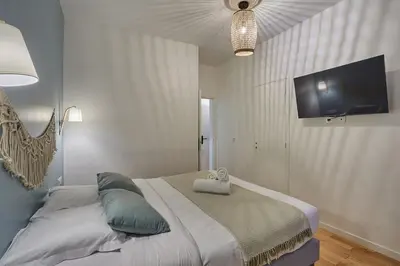 Un ou plusieurs lits dans un hébergement de l'établissement Apartment Center of Paris by Studio prestige