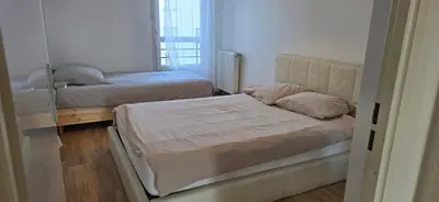 Un ou plusieurs lits dans un hébergement de l'établissement Bel appartement près du métro