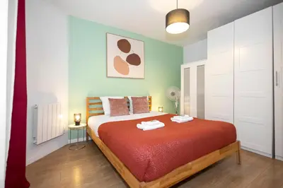 Un ou plusieurs lits dans un hébergement de l'établissement Nets Inn Apartments - La Villette