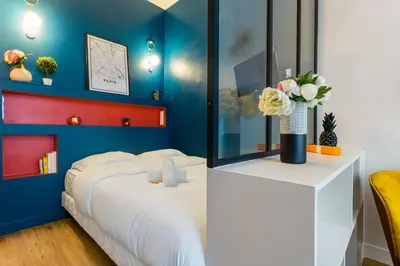 Un ou plusieurs lits dans un hébergement de l'établissement Cosy studio - Arc de Triomphe