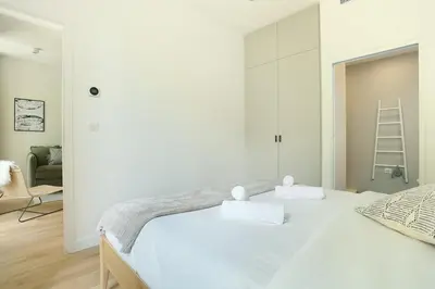 Un ou plusieurs lits dans un hébergement de l'établissement Apartment Center of Paris by Studio prestige