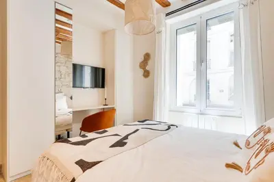 Un ou plusieurs lits dans un hébergement de l'établissement Opera Sentier Appartement avec Spa et Cinéma