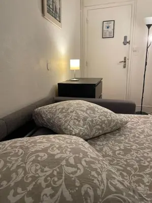 Un ou plusieurs lits dans un hébergement de l'établissement Studio Paris 14