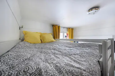 Un ou plusieurs lits dans un hébergement de l'établissement Studio calme proche Tour Eiffel