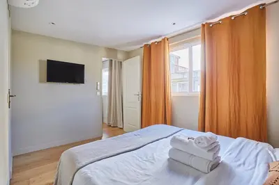 Un ou plusieurs lits dans un hébergement de l'établissement Apartment Center of Paris by Studio prestige