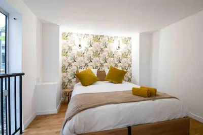 Un ou plusieurs lits dans un hébergement de l'établissement MONTMARTRE Sacré-Coeur, appartement jardin 6 à 8P