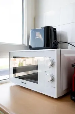 Cuisine ou kitchenette dans l'établissement Super studio tout équipé - III