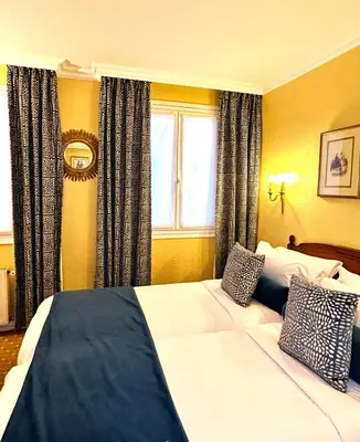 Un ou plusieurs lits dans un hébergement de l'établissement Hôtel de Varenne