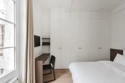 Un ou plusieurs lits dans un hébergement de l'établissement Adresse Prestigieuse: Appartement Luxueux Marais