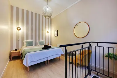 Un ou plusieurs lits dans un hébergement de l'établissement Charming Flat, quartier latin with a private cinema