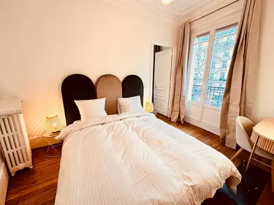 Un ou plusieurs lits dans un hébergement de l'établissement Charming 4-room flat near Eiffel Tower-8people-2 bedrooms