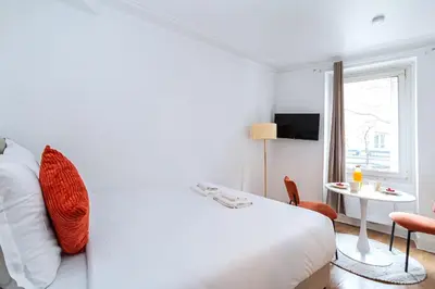 Un ou plusieurs lits dans un hébergement de l'établissement Studio Avenue Philippe Auguste