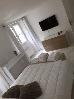 Un ou plusieurs lits dans un hébergement de l'établissement APPARTEMENT AU COEUR DU PARIS TOURISTIQUE