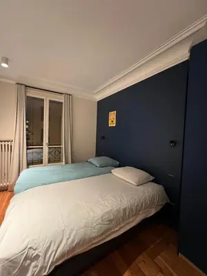 Un ou plusieurs lits dans un hébergement de l'établissement Elegance & Charm in Heart of Paris Daguerre