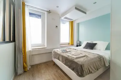 Un ou plusieurs lits dans un hébergement de l'établissement Nets Inn Apartments - Saint Lazare