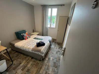 Un ou plusieurs lits dans un hébergement de l'établissement MA - Maison 10 min PARIS EXPOS - 8 chambres