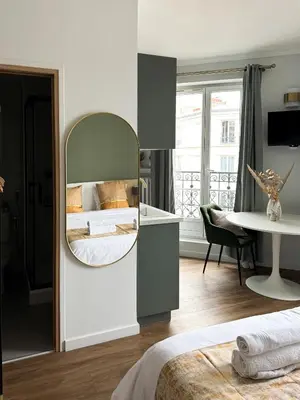 Un ou plusieurs lits dans un hébergement de l'établissement Studio de charme parisien