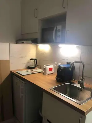 Cuisine ou kitchenette dans l'établissement Mignonnette