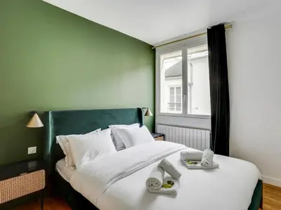 Un ou plusieurs lits dans un hébergement de l'établissement Amazing Apartment: 2BR/4P -Bastille/Saint Ambroise