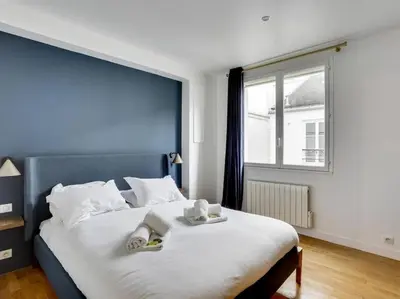 Un ou plusieurs lits dans un hébergement de l'établissement Amazing Apartment: 2BR/4P -Bastille/Saint Ambroise
