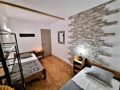 Un ou plusieurs lits dans un hébergement de l'établissement Appart' convivial 3 Ch 73m² à proximité de Paris