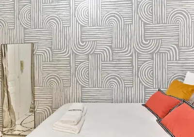 Un ou plusieurs lits dans un hébergement de l'établissement Appartement central proche Atelier des lumières
