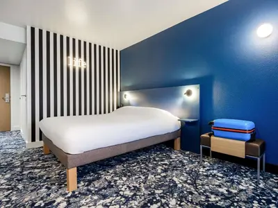 Un ou plusieurs lits dans un hébergement de l'établissement greet Hotel Paris 13 Porte d'Italie