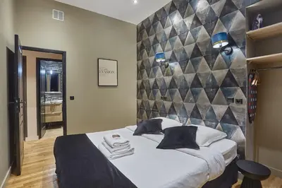 Un ou plusieurs lits dans un hébergement de l'établissement Apartment Center of Paris by Studio prestige