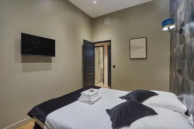 Un ou plusieurs lits dans un hébergement de l'établissement Apartment Center of Paris by Studio prestige