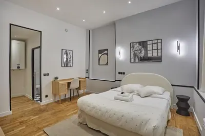 Un ou plusieurs lits dans un hébergement de l'établissement Apartment Center of Paris by Studio prestige