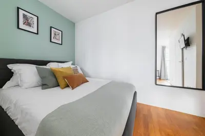 Un ou plusieurs lits dans un hébergement de l'établissement Cosy Apt Batignoles