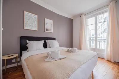 Un ou plusieurs lits dans un hébergement de l'établissement Nice Flat in Paris near Sacré Coeur