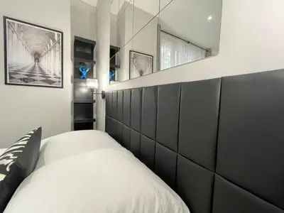Un ou plusieurs lits dans un hébergement de l'établissement Charming Studio Paris la Défense