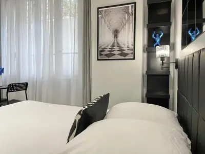 Un ou plusieurs lits dans un hébergement de l'établissement Charming Studio Paris la Défense