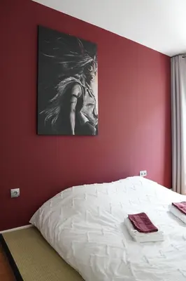 Un ou plusieurs lits dans un hébergement de l'établissement Charmant Appartement au Pré