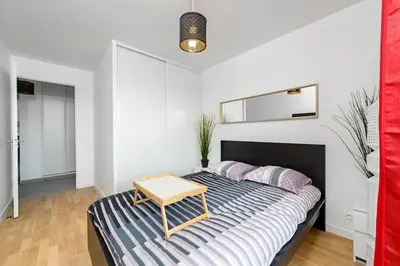 Un ou plusieurs lits dans un hébergement de l'établissement Magnifique appartement à proximité de Paris