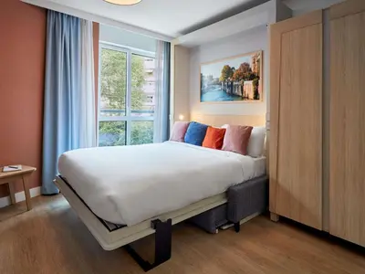 Un ou plusieurs lits dans un hébergement de l'établissement Aparthotel Adagio Paris Boulogne
