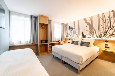 Un ou plusieurs lits dans un hébergement de l'établissement GREEN PARK HOTEL PARIS