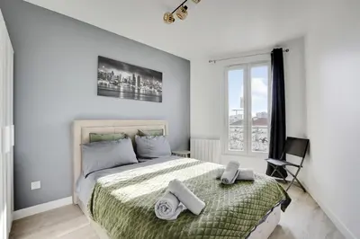 Un ou plusieurs lits dans un hébergement de l'établissement Appartement Suite 43 aux Portes de Paris
