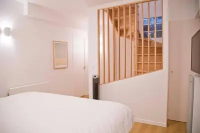 Un ou plusieurs lits dans un hébergement de l'établissement Luxury Apt Raspail Denfert