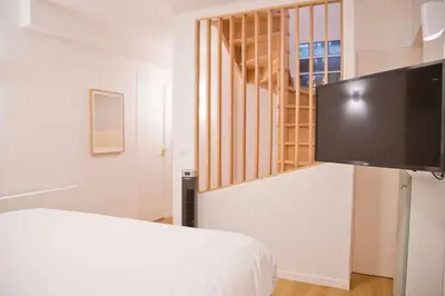 Un ou plusieurs lits dans un hébergement de l'établissement Luxury Apt Raspail Denfert