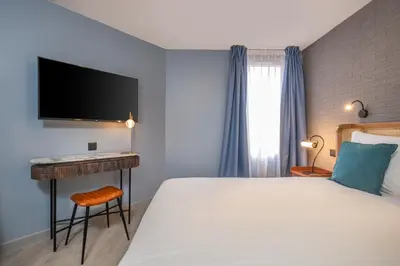 Un ou plusieurs lits dans un hébergement de l'établissement Appart'hôtel East Paris Suite